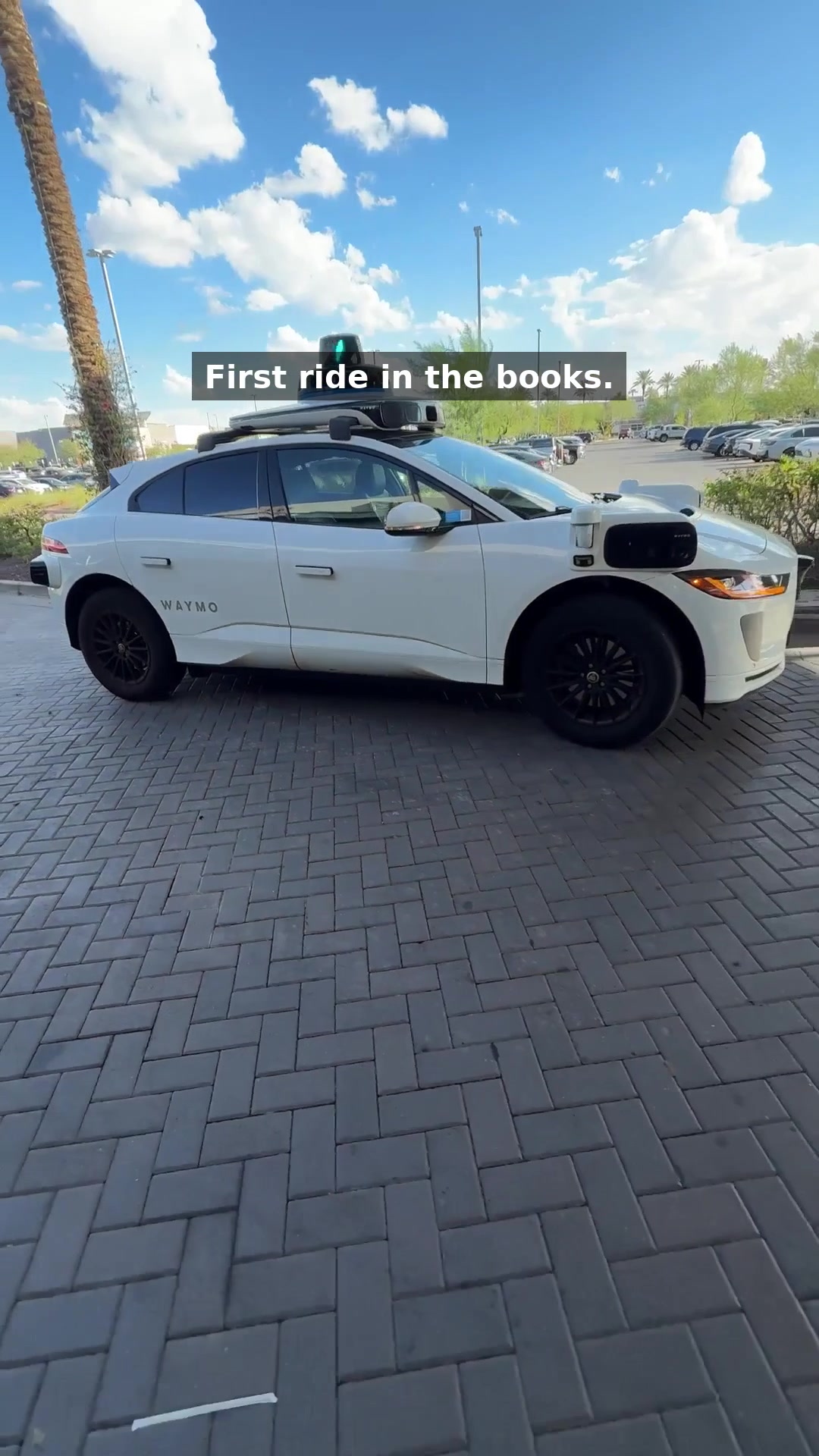 A full white Waymo vehicle parked outside after a first driverless ride near Tempe Marketplace in Tempe, Arizona